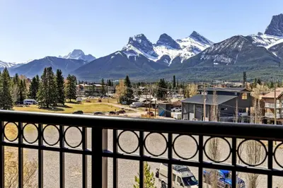 a view of the mountains from a balcony at Stunning Penthouse with Mtn Views Hot Tub and Pool in Canmore