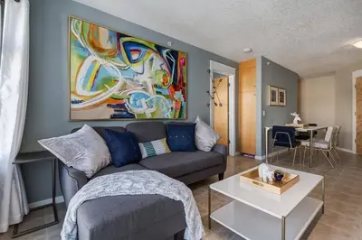 a living room with a couch and a table at Stylish Mountain View Condo with Gym in Canmore