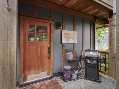 a front door of a house with a grill at Oceanfront Suite with Hot Tub - No Pets - Sleep 4 in Port Renfrew
