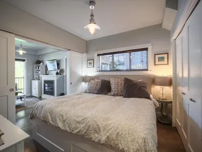 a bedroom with a large bed with a window at Oceanfront Suite with Hot Tub - No Pets - Sleep 4 in Port Renfrew