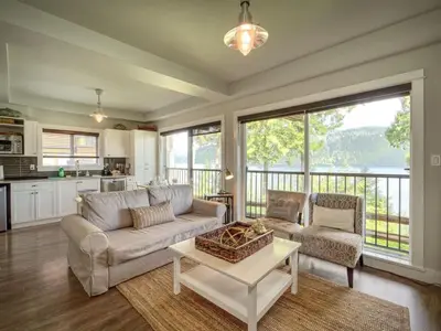 a living room with a couch and a table at Oceanfront Suite with Hot Tub - No Pets - Sleep 4 in Port Renfrew