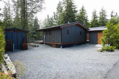 a couple of buildings in a parking lot at Explorer's Retreat Sauna & Bunkhouse & Fire pit in Port Renfrew