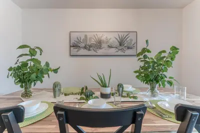 a dining room table with plants on the wall at Cozy Large Family Home near Lake, AC, Full Kitchen in Calgary
