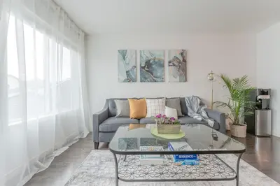 a living room with a couch and a glass table at Cozy Large Family Home near Lake, AC, Full Kitchen in Calgary