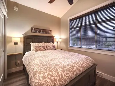a bedroom with a large bed and a window at Amazing Marina & Oceanfront View - Pet Friendly - Sleeps 6 in Port Renfrew