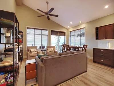 a living room with a couch and a ceiling fan at Amazing Marina & Oceanfront View - Pet Friendly - Sleeps 6 in Port Renfrew