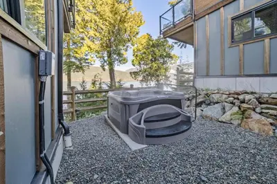a television sitting on the gravel outside of a house at Seaside Haven -Hot Tub with Oceanfront View in Port Renfrew
