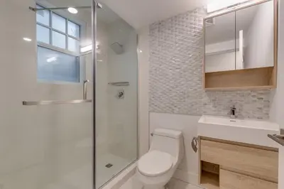 a bathroom with a toilet and a shower and a sink at Spacious Apartment Fully Equipped in Prime Location in Vancouver