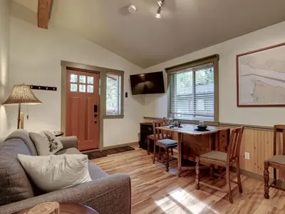 a living room with a couch and a table at Enclosed deck - Hot tub - Pet Friendly- gas stove in Port Renfrew