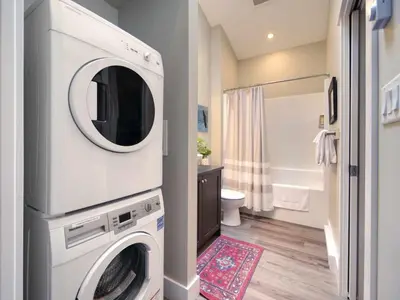 a bathroom with a washer and dryer in it at Amazing Oceanfront & Eagle Views pet Friendly - 2 bath in Port Renfrew