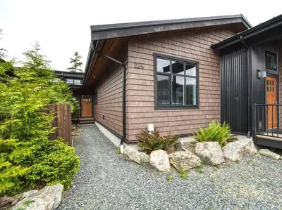 a small house with a gravel yard in front of it at Amazing Oceanfront & Eagle Views pet Friendly - 2 bath in Port Renfrew