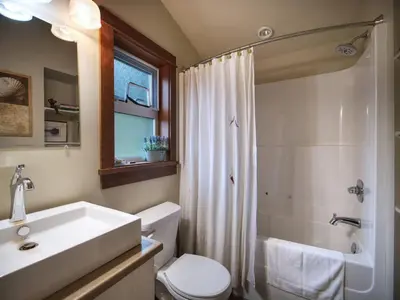 a bathroom with a sink and a toilet and a shower at Tiltin Hilton- Ocean View - Pet Friendly - sleep 4 in Port Renfrew