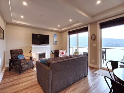 a living room with a couch and a fireplace at Oceanfront Relaxing & Stunning View - Pet Friendly in Port Renfrew