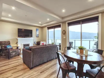 a living room with a table and a couch at Oceanfront Relaxing & Stunning View - Pet Friendly in Port Renfrew