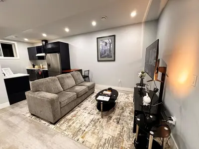 a living room with a couch and a table at Private 1BR Basement Suite in NE Calgary in Calgary