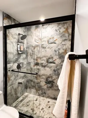 a shower with a glass door in a bathroom at Private 1BR Basement Suite in NE Calgary in Calgary