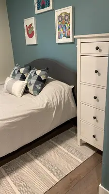 a bedroom with a bed and a white dresser at Beautiful Oasis in prime Vancouver BC with 2 bed and patio PLUS Studio available in Vancouver