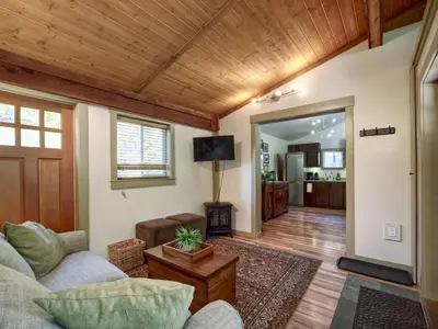a living room with a couch and a tv at A slice of paradise with Hot Tub - Pet Friendly in Port Renfrew