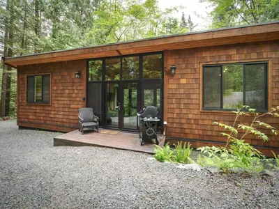 a small house with two chairs and a table in it at Private treed setting - no pets - garden view in Port Renfrew