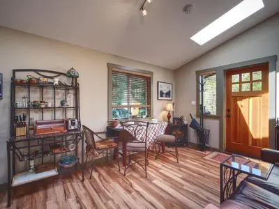 a living room with a couch and a table at Quiet Romantic Getaway - Non Pet Friendly in Port Renfrew