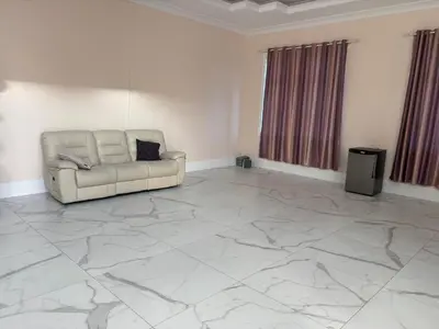 a living room with a couch on a marble floor at Comfortable Private Room in a Shared Home in Richmond