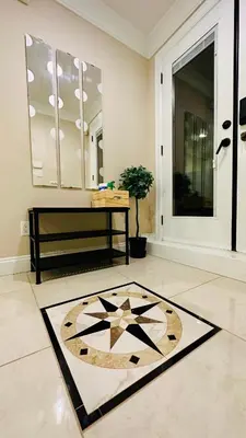 a living room with a table and a rug on the floor at Chic suite close to UBC in Vancouver