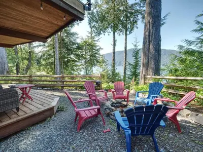 a group of colorful chairs sitting on a patio at Oceanfront view 2 entertainment areas -Pet Friendly in Port Renfrew