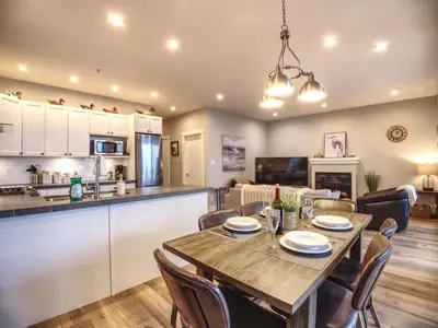 a dining room and kitchen with a table and chairs at The Salty Dog - Oceanfront Getaway - Great View - Pet Friendly in Port Renfrew