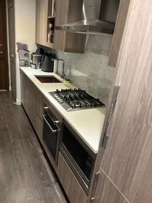 a kitchen with a stove and a counter top at Sleek Urban 1BR Retreat in Burnaby