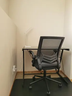 an office chair with a desk with a lamp at Quaint Lonsdale Suite in Red Deer