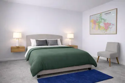 a bedroom with a green bed and a chair at Private ensuite bedroom with independent entrance in South Pandosy Gyro beach OC KGH in Kelowna