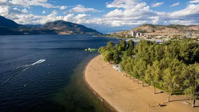 an aerial view of a beach with trees in the water at Private ensuite bedroom with independent entrance in South Pandosy Gyro beach OC KGH in Kelowna