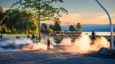 a group of people standing in front of a fountain at Private ensuite bedroom with independent entrance in South Pandosy Gyro beach OC KGH in Kelowna
