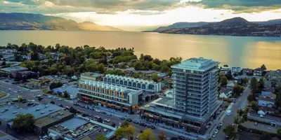 an aerial view of a large building next to the water at Private ensuite bedroom with independent entrance in South Pandosy Gyro beach OC KGH in Kelowna