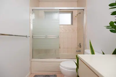 a bathroom with a shower and a toilet and a sink at Private Room with Full Amenities in Cozy House in Vancouver