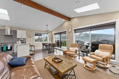 a living room with a couch and a table at Oceanview - Pet Friendly - Gas Fireplace - Wild Beauty in Port Renfrew