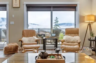 a living room with two chairs and a table at Oceanview - Pet Friendly - Gas Fireplace - Wild Beauty in Port Renfrew