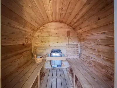 an inside view of a wooden cabin with a stove in it at Explorers Retreat Private Sauna - Pet Friendly in Port Renfrew
