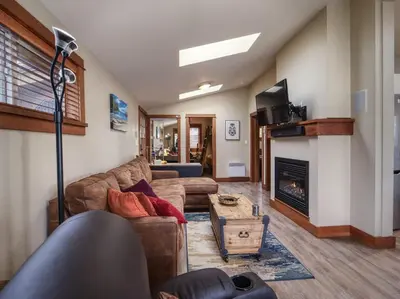 a living room with a couch and a fireplace at Going Coastal A - Oceanfront - Pet Friendly in Port Renfrew