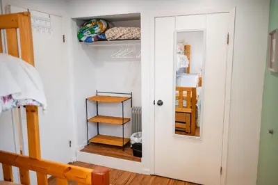 a room with a closet with shelves and a door at Spacious 2-Bedroom Basement Suite in Whitehorn, Close to Calgary Airport, Hospital, & Train in Calgary