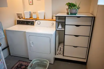 a small kitchen with a stove and a dishwasher at Spacious 2-Bedroom Basement Suite in Whitehorn, Close to Calgary Airport, Hospital, & Train in Calgary