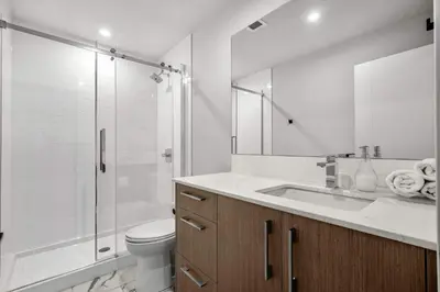 a bathroom with a toilet and a sink and a shower at Family Condo w Kids Den FREE Banff Pass in Calgary