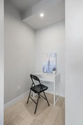 a black chair sitting next to a white desk at Family Condo w Kids Den FREE Banff Pass in Calgary