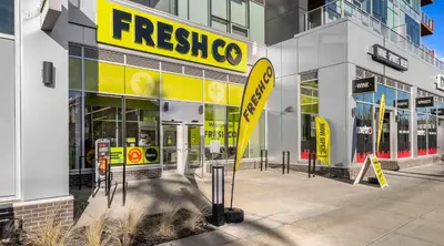 a store with a yellow sign on the side of a building at Family Condo w Kids Den FREE Banff Pass in Calgary