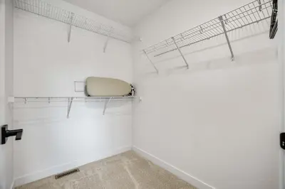 a white room with a chair sitting on a shelf at NEW Family 3BR Upper Suite w Kid's Play Den, Free Banff Pass in Calgary