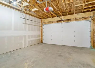 a garage with white doors and a basketball at Trendy Bridgeland, Fireplace, King Beds, AC in Calgary