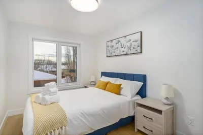 a bedroom with a bed and a window at Trendy Bridgeland, Fireplace, King Beds, AC in Calgary