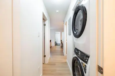 a hallway with a washer and dryer in a house at Wintergreen 26 by Outpost Whistler in Whistler