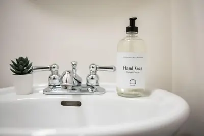 a bottle of hand soap sitting on top of a sink at Wintergreen 26 by Outpost Whistler in Whistler