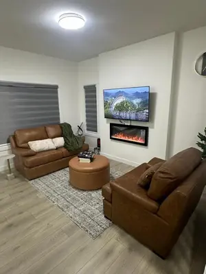a living room with two couches and a fireplace at Brand New 3 Bedroom house SW Edmonton in Edmonton
